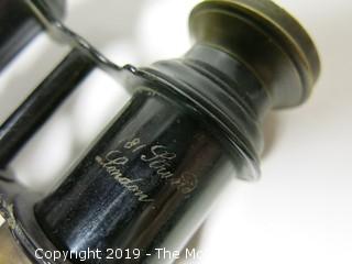 Binoculars; words etched "181 Strand; London" and "(illegible) Opticians"