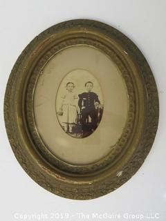 Portrait of children in formal attire; placed in oval frame; subject identification info on verso; 12 x 14"