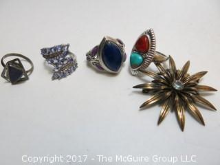 Collection of (4) sterling rings and brooch; sizes left to right in photo: 5 1/4;7;7 3/4;7