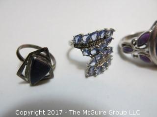 Collection of (4) sterling rings and brooch; sizes left to right in photo: 5 1/4;7;7 3/4;7