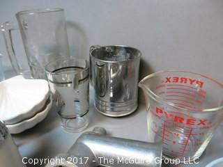 Collection of mid-century dishware including Corning, Pyrex, sifter and liter glass mug