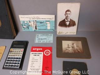 Collection including early photographs, playbills, M-C advertising, and pocket calculator