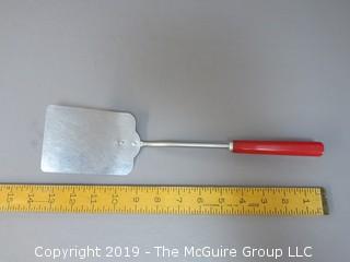 Slotted Spatula with bakelite red handle; marked Corona