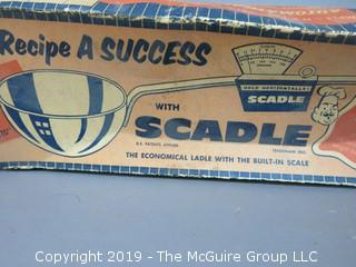 "Scadle"; "The Economical Ladle with the Built In Scale"; in original box