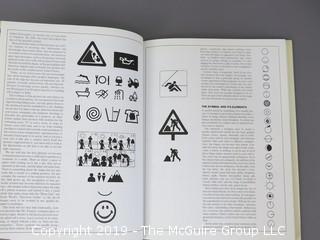 Book Title: "Designing Pictorial Symbols"; authored by Nigel Holmes with Rose DeNeve; published by Watson-Guptill; 1985