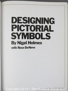 Book Title: "Designing Pictorial Symbols"; authored by Nigel Holmes with Rose DeNeve; published by Watson-Guptill; 1985