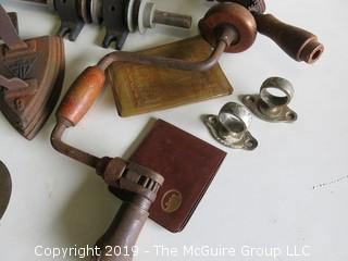 Collection of old tools including toolbox, arbor, (2) hand drills, hatchet blade, flat iron and NIB clothespins  