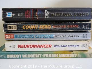 Collection of books including including authors William Gibson and Frank Herbert