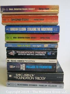 Collection of books including authors Harlan Ellison and Isaac Asinov