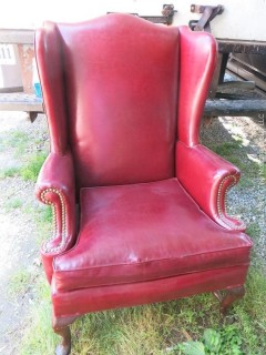 Red Leather Wing Back Chair (Note: needs some re-stitching; bottom wooden stretcher has been re-glued)