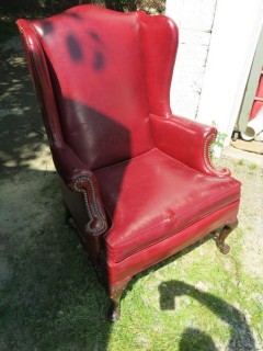 Red Leather Wing Back Chair (Note: needs some re-stitching; bottom wooden stretcher has been re-glued)