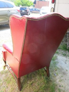 Red Leather Wing Back Chair (Note: needs some re-stitching; bottom wooden stretcher has been re-glued)