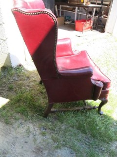 Red Leather Wing Back Chair (Note: needs some re-stitching; bottom wooden stretcher has been re-glued)