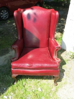 Red Leather Wing Back Chair (Note: needs some re-stitching; bottom wooden stretcher has been re-glued)