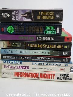 Collection of books including authors Paul Park, Les Roberts, Khaled Hosseini, Alan Furst, D. Tannen and Naguib Mahfouz