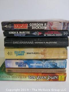 Collection of books including authors Dickson, McIntyre, Aldiss, Niven, Mieville