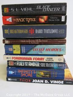 Collection of books including authors S.L. Viehl, Denise Litytle, Harry Turtledove, Norman Spinrad, Andre Norton, Wil McCarthy, Daniel Brin and Joan D. Vinge 