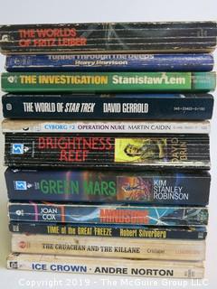 Collection of books including authors Harry Harrison, Stanislaw Lem, David Gerrold, Martin Caidin, David Brin, Kim S. Robinson, Joan Cox, Robert Silverberg, Christabel and Andre Norton 