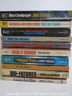 Collection of books including authors John Varley, Philip Jose Farmer, Norman Spinrad, Richard A Lupoff, Robert Adams, Roger Elwood, Larry Niven, C.S. Lewis, Pamela Sargent and William F. Nolan   