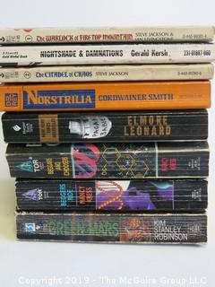 Collection of books including authors Steve Jackson, Ian Livingstone, Gerald Kersh, Cordwainer Smith, Elmore Leonard, Nancy Kress and Kim S. Robinson