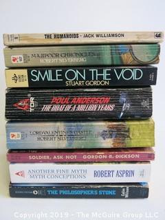 Collection of books including authors Williamson, Silverberg, Anderson, Dickson, Asprin and Wilson