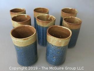 Set of (8) hand thrown glazed pottery cups; signed on base 