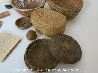 Collection including baskets, wooden combs, an ostrich egg and a handmade paper book.