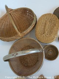 Collection including baskets, wooden combs, an ostrich egg and a handmade paper book.