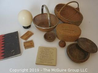 Collection including baskets, wooden combs, an ostrich egg and a handmade paper book.