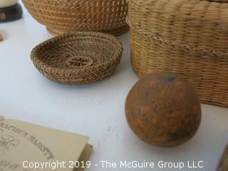 Collection including baskets, wooden combs, an ostrich egg and a handmade paper book.