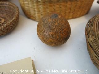 Collection including baskets, wooden combs, an ostrich egg and a handmade paper book.