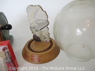 Collection including an oversized wooden yo-yo, a vintage savings bank, and a miniature "Betsy Ross" sewing machine