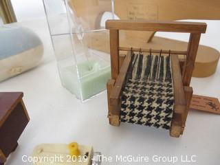 Collection including miniature houndstooth loom, sewing table and woven baby footies in shadow box