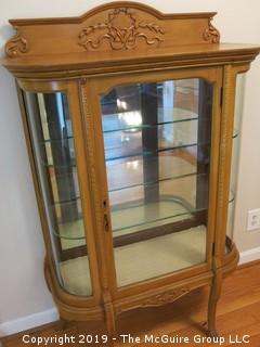 Wooden vitrine with glass panel door, curved glass sides, two glass shelves, mirrored back, raised on shaped legs; 36W x 14D x 58"Tall {Description altered 06.13.2019 @ 3:09pm ET}