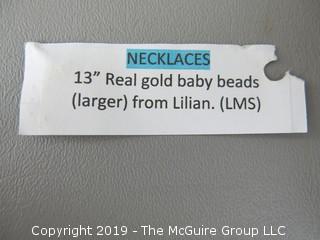 13" 14k gold baby beads; strung on non-gold chain; needs to be restrung; 10.2g