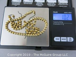 13" 14k gold baby beads; strung on non-gold chain; needs to be restrung; 10.2g