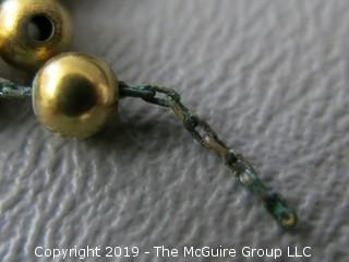 13" 14k gold baby beads; strung on non-gold chain; needs to be restrung; 10.2g