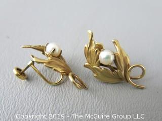 Pair of 14k gold clip on earrings set with single pearls; 4.5g