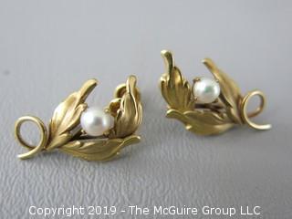 Pair of 14k gold clip on earrings set with single pearls; 4.5g