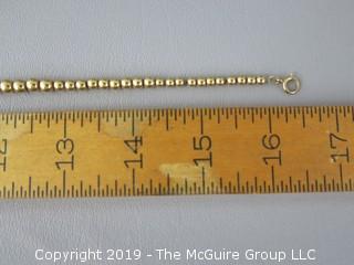 16 1/2" string of graduated faux gold beads