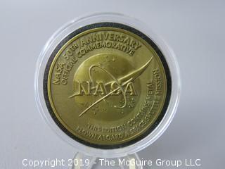 NASA 50th Anniversary Official Commemorative medallion, containing metal flown aboard a space shuttle mission