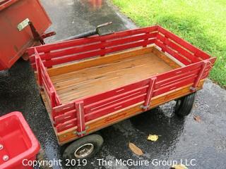 Collection including wooden red Wagon, tractor pulled metal dump wagon and (2) fertilizer spreaders