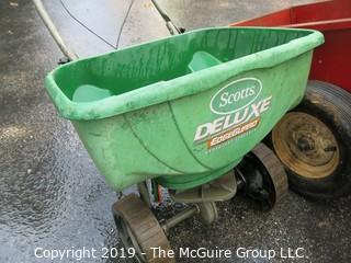 Collection including wooden red Wagon, tractor pulled metal dump wagon and (2) fertilizer spreaders