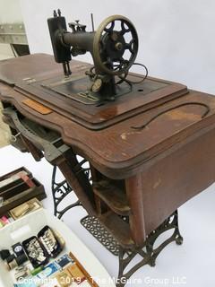 "New Home" Sewing Cabinet and Matching Machine. Treadle style. Electric light attachment. Drawers contain many vintage accessories.  See all the photos; 35W x 19D x 30"T