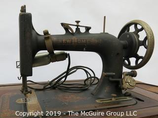 "New Home" Sewing Cabinet and Matching Machine. Treadle style. Electric light attachment. Drawers contain many vintage accessories.  See all the photos; 35W x 19D x 30"T