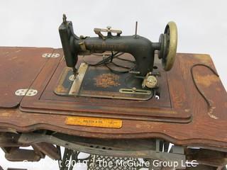 "New Home" Sewing Cabinet and Matching Machine. Treadle style. Electric light attachment. Drawers contain many vintage accessories.  See all the photos; 35W x 19D x 30"T