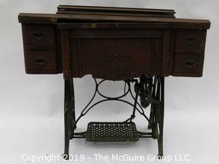 "New Home" Sewing Cabinet and Matching Machine. Treadle style. Electric light attachment. Drawers contain many vintage accessories.  See all the photos; 35W x 19D x 30"T