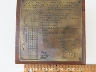 Marine Master Box containing brass compass. brass telescope, brass scale with chart, brass spirit level, brass alidade with coloured glass and brass boat clinometer.  