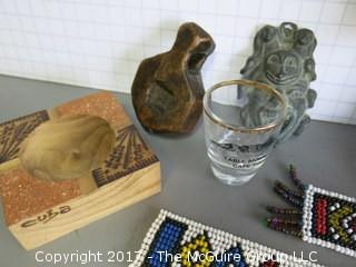 Collection including carved elephants, stone pyramid, bead works and metal mask