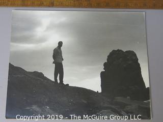 Photo: unaccredited: man in silhouette by rocks on board 